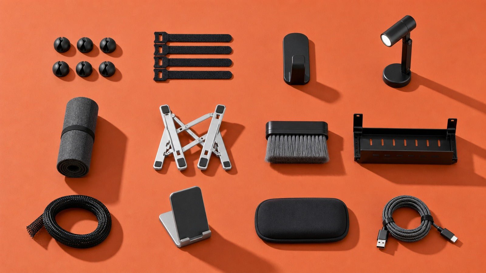 Twelve affordable desk accessories arranged in a terracotta studio flat lay