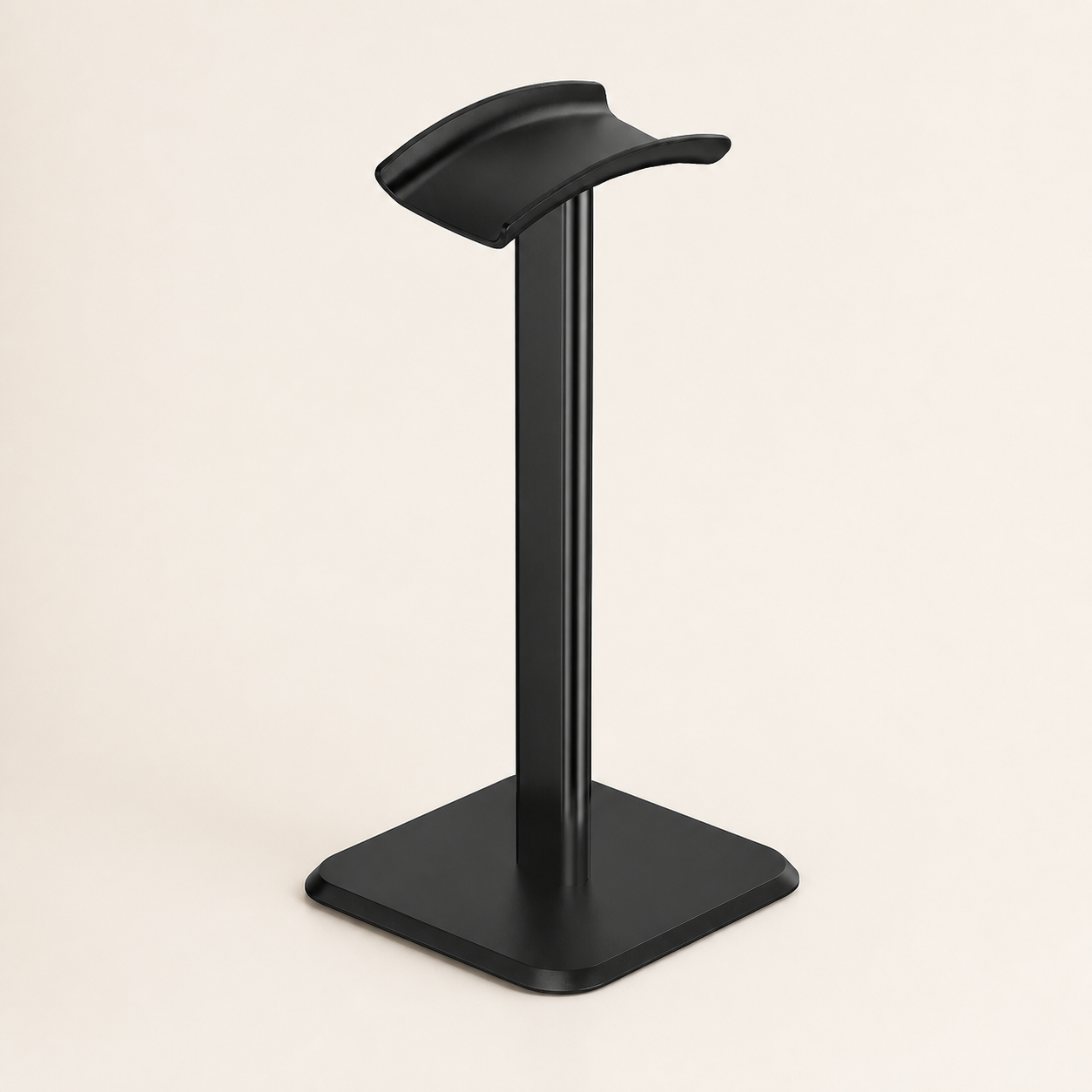 Black desktop headphone stand on a warm off-white background